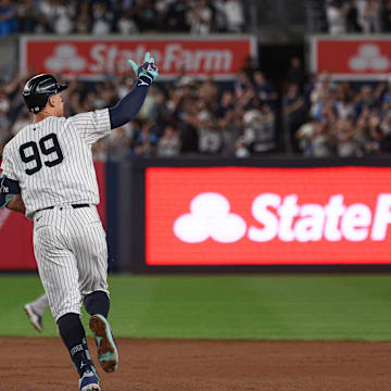 New York Yankees center fielder Aaron Judge (99) celebrates while running the bases after hitting a grand slam home run during the seventh inning against the Boston Red Sox at Yankee Stadium on Sept 13.