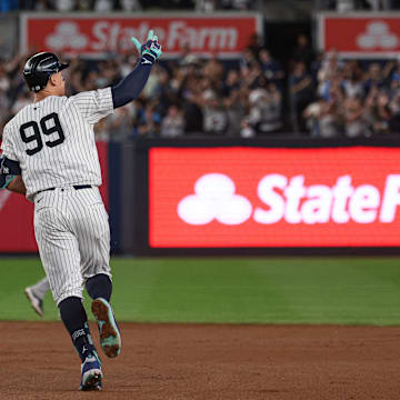 Sep 13, 2024; Bronx, New York, USA; New York Yankees center fielder Aaron Judge (99) celebrates while running the bases after hitting a grand slam home run during the seventh inning against the Boston Red Sox at Yankee Stadium.