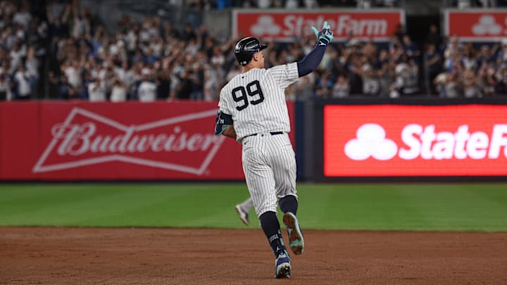 Sep 13, 2024; Bronx, New York, USA; New York Yankees center fielder Aaron Judge (99) celebrates while running the bases after hitting a grand slam home run during the seventh inning against the Boston Red Sox at Yankee Stadium.