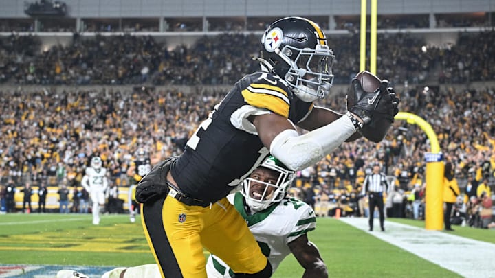 Oct 20, 2024; Pittsburgh, Pennsylvania, USA; Pittsburgh Steelers wide receiver George Pickens (14) catches an 11 yard touchdown pass in front of New York Jets cornerback Brandin Echols (26) during the second quarter at Acrisure Stadium. Mandatory Credit: Barry Reeger-Imagn Images