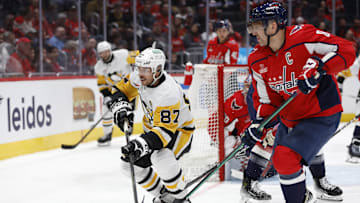 Apr 4, 2024; Washington, District of Columbia, USA; Pittsburgh Penguins center Sidney Crosby (87) and Washington Capitals left wing Alex Ovechkin (8) chase the puck in the second period at Capital One Arena. Mandatory Credit: Geoff Burke-Imagn Images