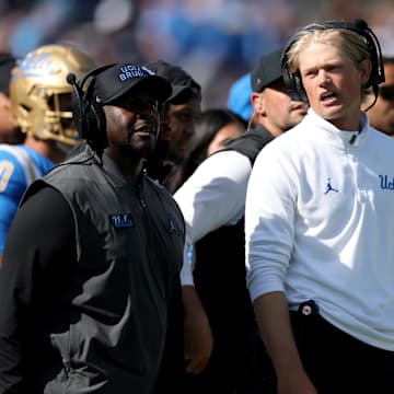 Oct 4, 2025; Pasadena, California, USA;  UCLA Bruins interim head coach Tim Skipper (left) and  new offensive coordinator Jerry Neuheisel (right) on the sideline during second half against the Penn State Nittany Lions at Rose Bowl. Mandatory Credit: Kiyoshi Mio-Imagn Images