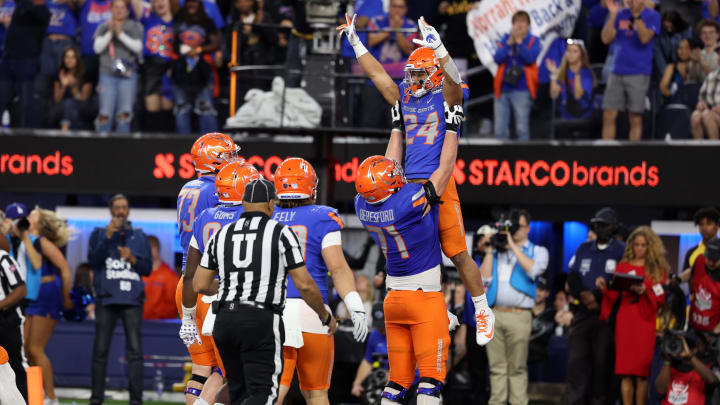 Dec 16, 2023; Inglewood, CA, USA; Boise State Broncos running back George Holani (24) celebrates with offensive lineman Cade Beresford (71) after scoring a touchdown in the second quarter against the UCLA Bruins during the LA Bowl at SoFi Stadium. Mandatory Credit: Kiyoshi Mio-USA TODAY Sports