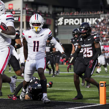Nov 15, 2025; Cincinnati, Ohio, USA;  Arizona Wildcats running back Kedrick Reescano (3) carries the ball for a touchdown against the Cincinnati Bearcats in the second half at Nippert Stadium. Mandatory Credit: Aaron Doster-Imagn Images