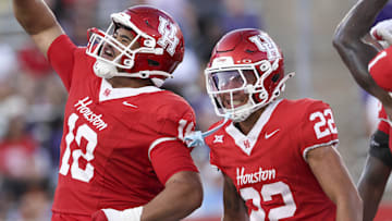 Aug 28, 2025; Houston, Texas, USA; Houston Cougars defensive lineman Khalil Laufau (18) celebrates with defensive back Marc Stampley II (22) after a defenisve play during the first quarter against the Stephen F. Austin Lumberjacks at TDECU Stadium. Mandatory Credit: Troy Taormina-Imagn Images