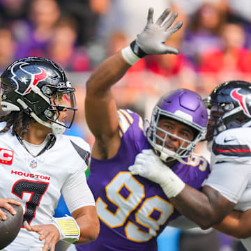 Sep 22, 2024; Minneapolis, Minnesota, USA; Houston Texans quarterback C.J. Stroud (7) drops back to pass against the Minnesota Vikings defensive tackle Jerry Tillery (99) in the first quarter at U.S. Bank Stadium. Mandatory Credit: Brad Rempel-Imagn Images