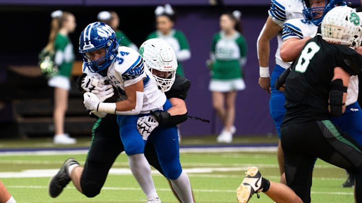 Osage's Alex Machin tackles Van Meter's Christian Williams during the semifinal round of the Iowa high school football state championships at the UNI-Dome on Saturday, Nov. 15, 2025, in Cedar Falls.