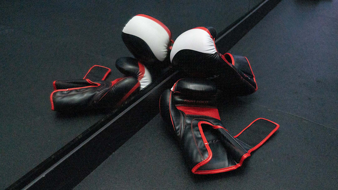 A pair of boxing gloves lay on the ground
