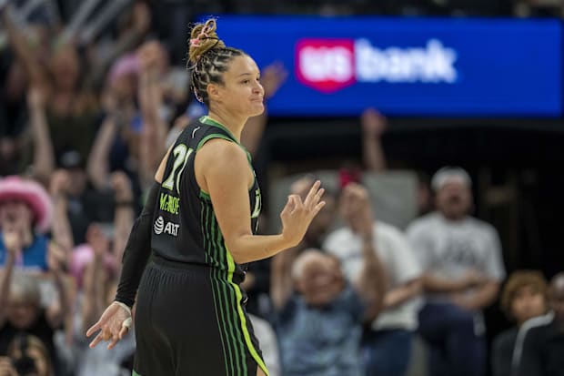 Minnesota Lynx guard Kayla McBride celebrates making a three point shot. 