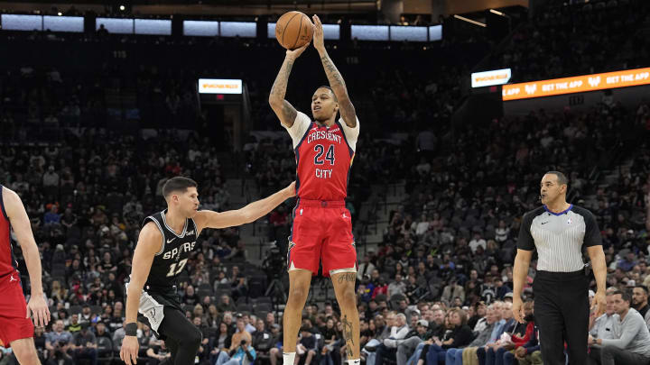 Feb 2, 2024; San Antonio, Texas, USA; New Orleans Pelicans guard Jordan Hawkins (24) shoots over San Antonio Spurs forward Doug McDermott (17) during the first half at Frost Bank Center.