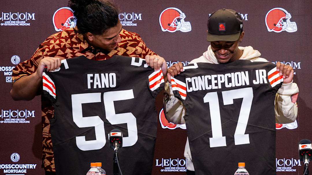 Apr 24, 2026; Berea, OH, USA; Cleveland Browns first round draft picks Spencer Fano, left, and KC Concepcion hold their new jerseys during an introductory press conference at CrossCountry Mortgage Campus. Mandatory Credit: Ken Blaze-Imagn Images