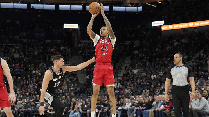 Feb 2, 2024; San Antonio, Texas, USA; New Orleans Pelicans guard Jordan Hawkins (24) shoots over San Antonio Spurs forward Doug McDermott (17) during the first half at Frost Bank Center. 