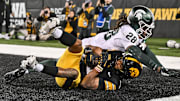 Nov 22, 2025; Iowa City, Iowa, USA; Iowa Hawkeyes wide receiver Jacob Gill (5) catches the game tying touchdown as Michigan State Spartans defensive back Dontavius Nash (28) defends during the fourth quarter at Kinnick Stadium. Mandatory Credit: Jeffrey Becker-Imagn Images