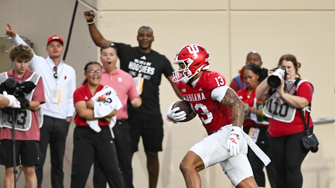 Oct 18, 2025; Bloomington, Indiana, USA; Indiana Hoosiers wide receiver Elijah Sarratt (13) runs after a catch for a touchdown during the first half against the Michigan State Spartans at Memorial Stadium. Mandatory Credit: Robert Goddin-Imagn Images