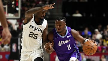 Jul 14, 2025; Las Vegas, NV, USA;  Utah Jazz guard Isaiah Collier (8) drives the ball against San Antonio Spurs forward David Jones-Garcia (25) during the first half of a NBA basketball game at the Thomas & Mack Center. Mandatory Credit: Lucas Peltier-Imagn Images