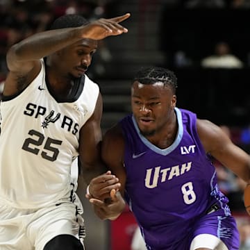 Jul 14, 2025; Las Vegas, NV, USA;  Utah Jazz guard Isaiah Collier (8) drives the ball against San Antonio Spurs forward David Jones-Garcia (25) during the first half of a NBA basketball game at the Thomas & Mack Center. Mandatory Credit: Lucas Peltier-Imagn Images