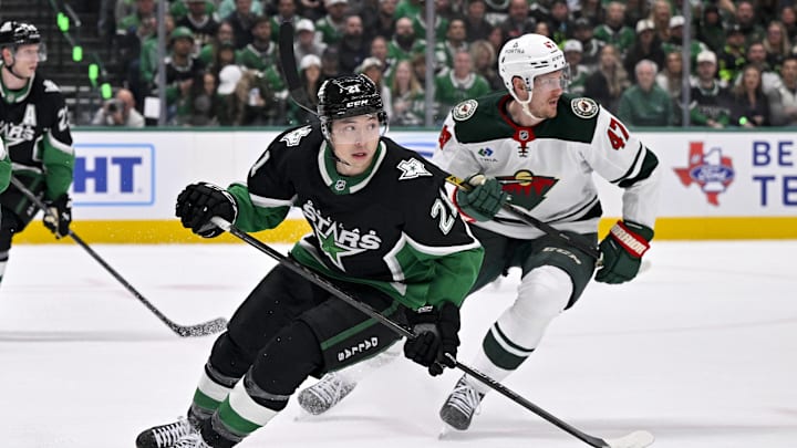 Apr 20, 2026; Dallas, Texas, USA; Dallas Stars left wing Jason Robertson (21) and Minnesota Wild center Michael McCarron (47) look for the puck during the game between the Stars and the Wild in game two of the first round of the 2026 Stanley Cup Playoffs at American Airlines Center. Mandatory Credit: Jerome Miron-Imagn Images