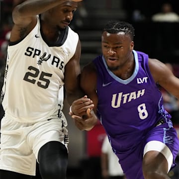 Jul 14, 2025; Las Vegas, NV, USA;  Utah Jazz guard Isaiah Collier (8) drives the ball against San Antonio Spurs forward David Jones-Garcia (25) during the first half of a NBA basketball game at the Thomas & Mack Center. Mandatory Credit: Lucas Peltier-Imagn Images