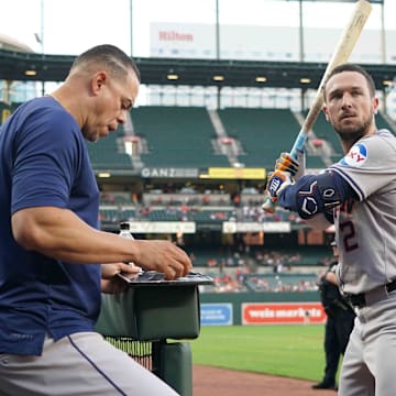 Aug 22, 2024; Baltimore, Maryland, USA; Houston Astros designated hitter Alex Bregman (right) works with hitting coach Alex Cintron (left) prior to the game against the Baltimore Orioles at Oriole Park at Camden Yards.