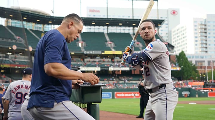 Aug 22, 2024; Baltimore, Maryland, USA; Houston Astros designated hitter Alex Bregman (right) works with hitting coach Alex Cintron (left) prior to the game against the Baltimore Orioles at Oriole Park at Camden Yards.