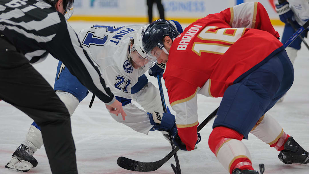Mar 3, 2025; Sunrise, Florida, USA; Tampa Bay Lightning center Brayden Point (21) and Florida Panthers center Aleksander Barkov (16) face-off during the first period at Amerant Bank Arena. Mandatory Credit: Sam Navarro-Imagn Images
