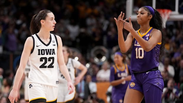 Angel Reese (10) shows Iowa Caitlin Clark her ring finger during the final seconds of the women's 2023 NCAA Tournament nation