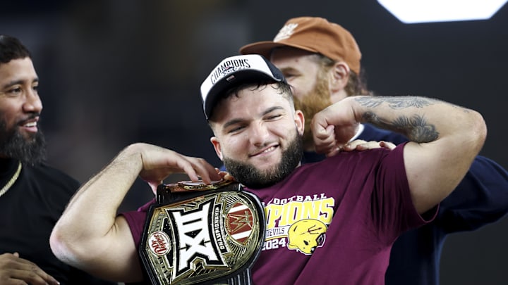 Arizona State's Cam Skattebo celebrates with an WWE Championship belt after the Sun Devils beat Iowa State on Dec. 7, 2024.