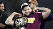 Arizona State Sun Devils running back Cam Skattebo (4) celebrates with the WWE Championship belt after being named the most outstanding player after the game against the Iowa State Cyclones.