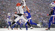 Cincinnati Bengals wide receiver Ja'Marr Chase (1) leaps fo a catch in the zone as Buffalo Bills linebacker Matt Milano (58) defends in the second quarter during an NFL divisional playoff football game between the Cincinnati Bengals and the Buffalo Bills, Sunday, Jan. 22, 2023, at Highmark Stadium in Orchard Park, N.Y. The catch was ruled incomplete upon further review.