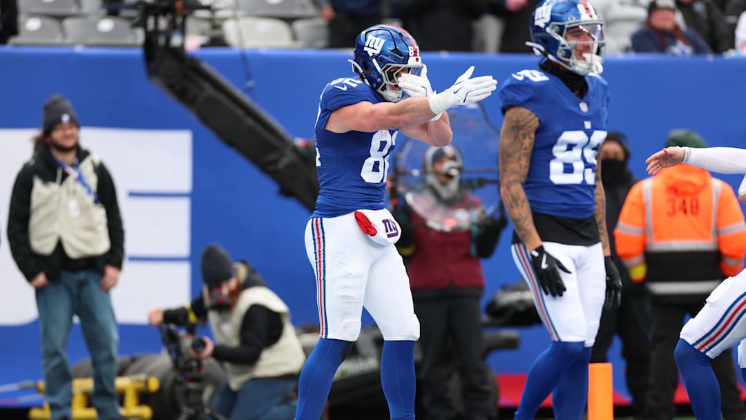 Jan 4, 2026; East Rutherford, New Jersey, USA; New York Giants tight end Daniel Bellinger (82) celebrates after scoring a touchdown during the second quarter against the Dallas Cowboys at MetLife Stadium.  