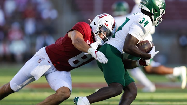 Sep 7, 2024; Stanford, California, USA; Cal Poly Mustangs running back Kendric Sanders (34) is tackled by Stanford Cardinal linebacker Tristan Sinclair (8) during the second half at Stanford Stadium. Mandatory Credit: Sergio Estrada-Imagn Images