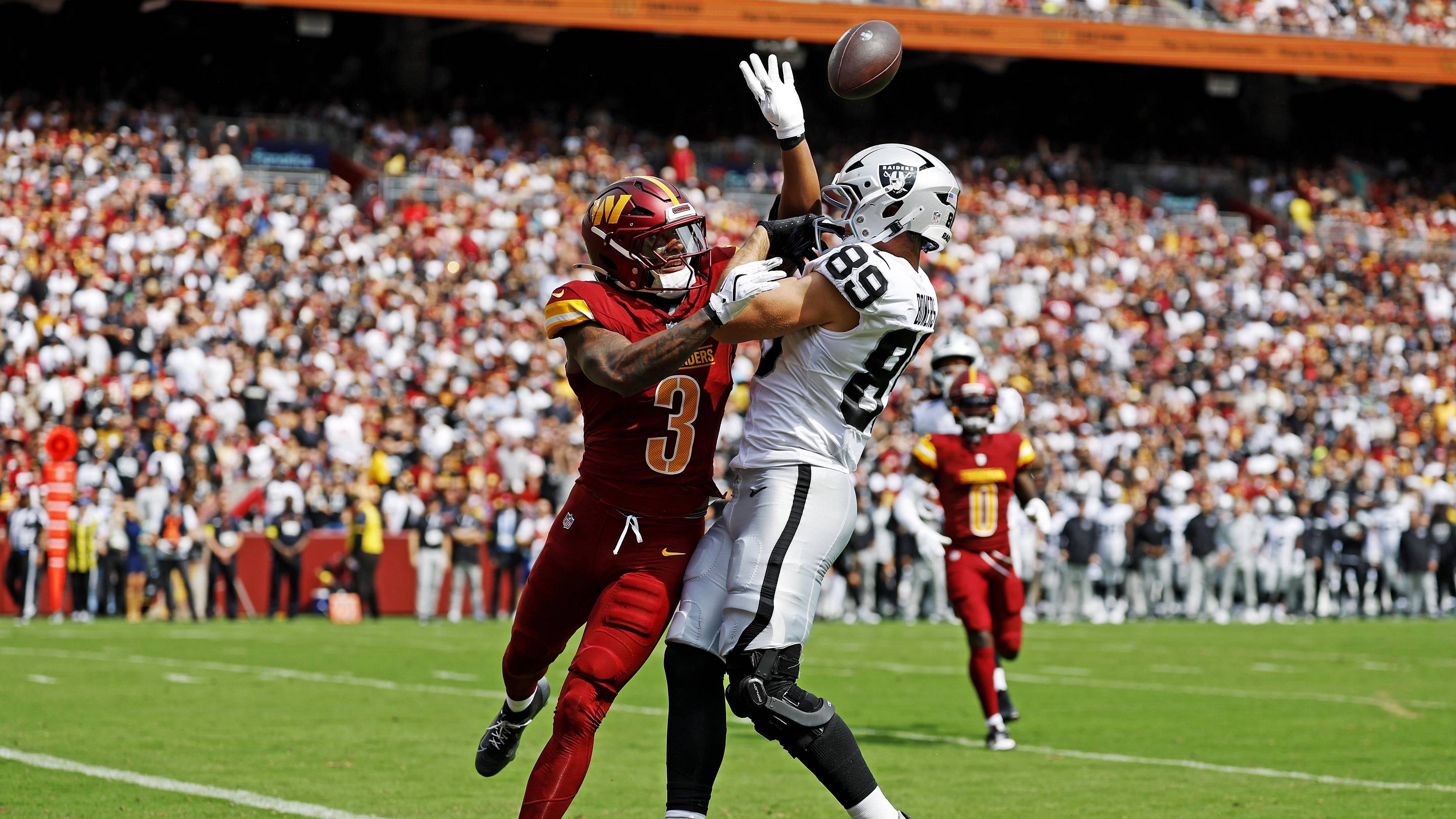 Sep 21, 2025; Landover, Maryland, USA; Washington Commanders safety Will Harris (3) breaks up a pass intended for Las Vegas Raiders tight end Brock Bowers (89) during the first half at Northwest Stadium. Mandatory Credit: Geoff Burke-Imagn Images