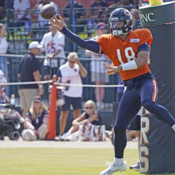 Caleb Williams whips the ball out to a receiver during passing drills at Bears training camp. His over/under for passing yards this year is 3,475.5 yards.