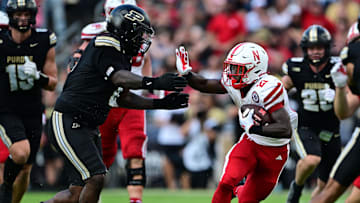 Sep 28, 2024; West Lafayette, Indiana, USA; Nebraska Cornhuskers running back Emmett Johnson (21) runs into Purdue Boilermakers defensive lineman Damarjhe Lewis (34) during the second half at Ross-Ade Stadium.