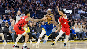 Mar 10, 2025; San Francisco, California, USA; Golden State Warriors forward Jimmy Butler III (10) drives past Portland Trail Blazers guard Shaedon Sharpe (17) and guard Anfernee Simons (1) during the second quarter at Chase Center. Mandatory Credit: John Hefti-Imagn Images