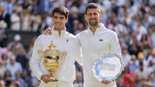 Carlos Alcaraz of Spain and Novak Djokovic of Serbia pose with their trophies after the men’s singles final at Wimbledon.