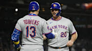 Mets first baseman Pete Alonso is greeted by catcher Luis Torrens after scoring against the Cubs during the first inning at Wrigley Field.