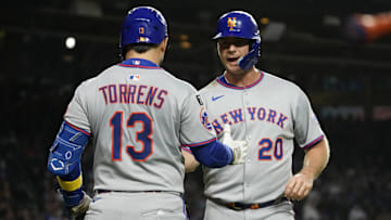 Mets first baseman Pete Alonso is greeted by catcher Luis Torrens after scoring against the Cubs during the first inning at Wrigley Field.