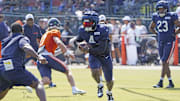 D'Andre Swift runs with the ball during drills at training camp last year. The Bears have two joint practices at 2025 camp.