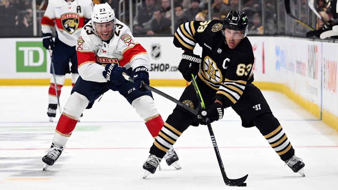 Oct 30, 2023; Boston, Massachusetts, USA; Boston Bruins left wing Brad Marchand (63) skates against Florida Panthers center Carter Verhaeghe (23) during the third period at the TD Garden. Mandatory Credit: Brian Fluharty-Imagn Images
