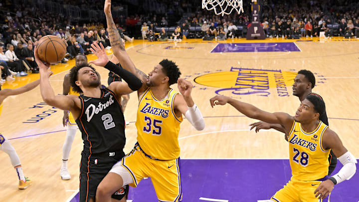 Feb 13, 2024; Los Angeles, California, USA;  Los Angeles Lakers forward Christian Wood (35) blocks a shot by Detroit Pistons guard Cade Cunningham (2) in the second half at Crypto.com Arena. Mandatory Credit: Jayne Kamin-Oncea-USA TODAY Sports