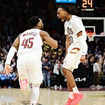 Jan 8, 2025; Cleveland, Ohio, USA; Cleveland Cavaliers guard Donovan Mitchell (45) and guard Darius Garland (10) celebrate after Mitchell made a three point basket during the second half against the Oklahoma City Thunder at Rocket Mortgage FieldHouse. Mandatory Credit: Ken Blaze-Imagn Images