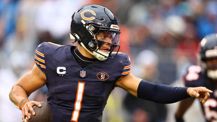 Dec 10, 2023; Chicago, Illinois, USA; Chicago Bears quarterback Justin Fields (1) rushes for a touchdown against the Detroit Lions during the second half at Soldier Field. Mandatory Credit: Mike Dinovo-USA TODAY Sports