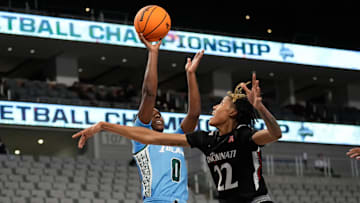 Mar 6, 2023; Fort Worth, TX, USA; Tulane Green Wave guard Kyren Whittington (0) shoots against Cincinnati Bearcats forward Malea Williams (22) during the second half at Dickies Arena. 