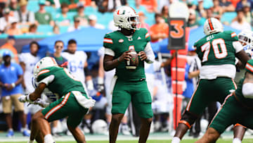 Nov 2, 2024; Miami Gardens, Florida, USA; Miami Hurricanes quarterback Cam Ward (1) looks for a passing option against the Duke Blue Devils during the second quarter at Hard Rock Stadium. Mandatory Credit: Sam Navarro-Imagn Images