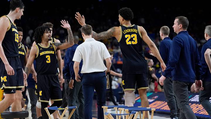 Michigan guard Elliot Cadeau (3) high-fives teammate Yaxel Lendeborg (23) in the second half of their Final Four game against Arizona at Lucas Oil Stadium in Indianapolis on Saturday, April 4, 2026.