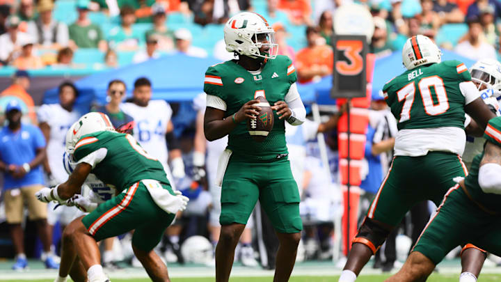 Nov 2, 2024; Miami Gardens, Florida, USA; Miami Hurricanes quarterback Cam Ward (1) looks for a passing option against the Duke Blue Devils during the second quarter at Hard Rock Stadium. Mandatory Credit: Sam Navarro-Imagn Images
