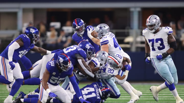 Nov 12, 2023; Arlington, Texas, USA; Dallas Cowboys running back Tony Pollard (20) is tackled by the New York Giants defense in the first quarter at AT&T Stadium.  