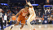 Mar 14, 2025; Nashville, TN, USA;  Texas Longhorns guard Tre Johnson (20) drives into Tennessee Volunteers guard Jahmai Mashack (15) during the second half at Bridgestone Arena. Mandatory Credit: Steve Roberts-Imagn Images