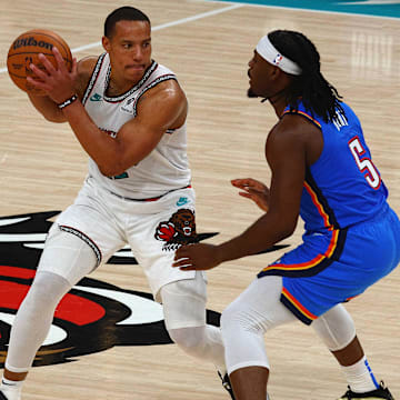 Apr 24, 2025; Memphis, Tennessee, USA; Memphis Grizzlies guard Desmond Bane (22) handles the ball as Oklahoma City Thunder guard Luguentz Dort (5) defends 